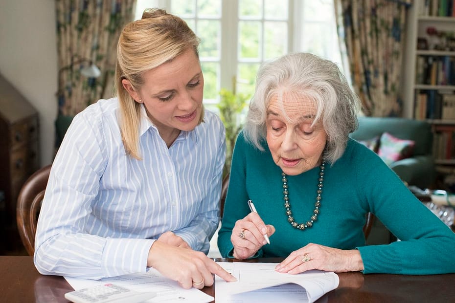 Woman Helping Senior with aPower of Attorney | HARTSFIELD & EGBERT, PLLC Woman Helping Senior with a Power of Attorney